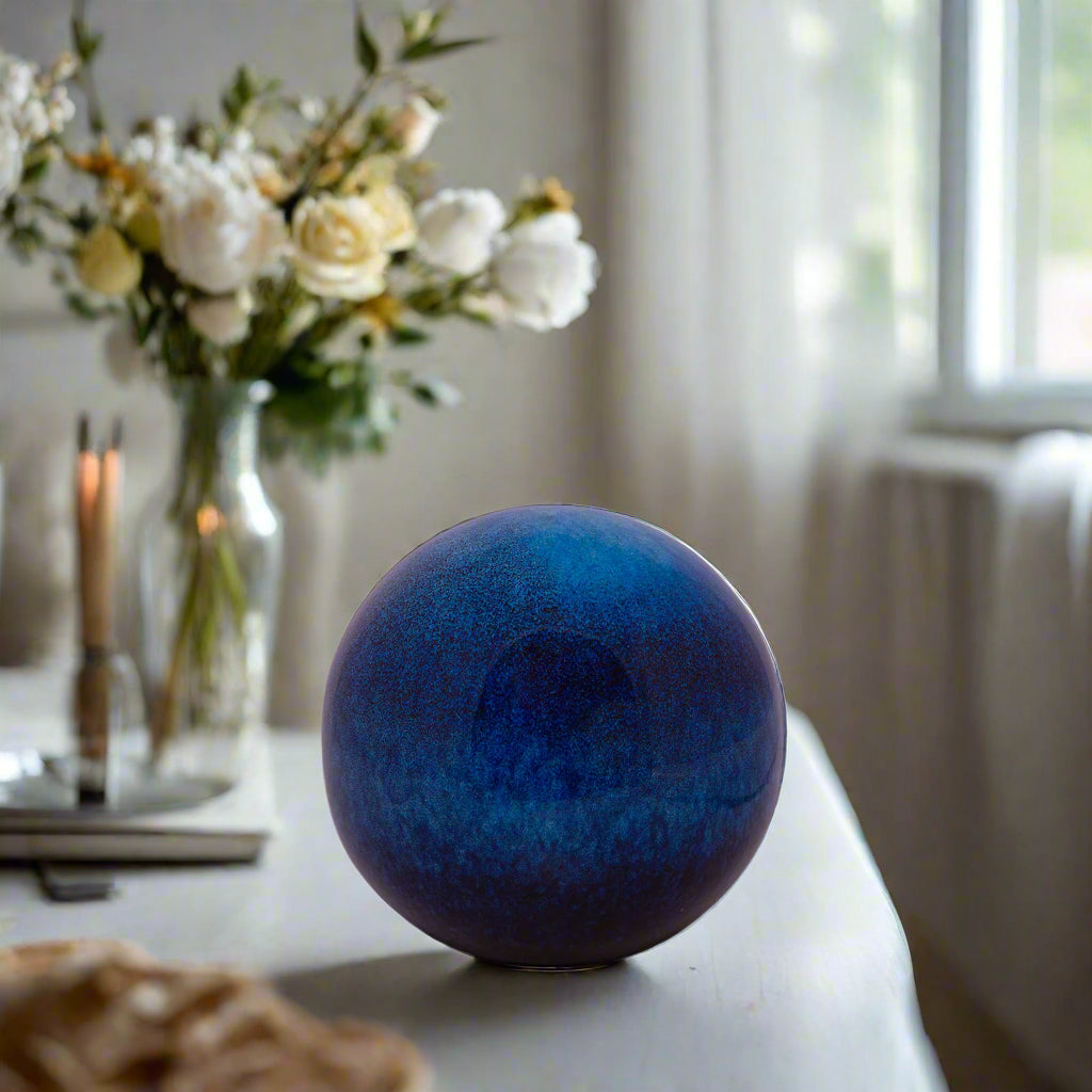 Blue spherical object on a white background