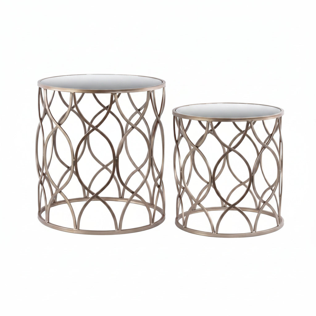 Two round nesting accent tables with a metallic gold finish and mirror tops, featuring an intersecting wave design.