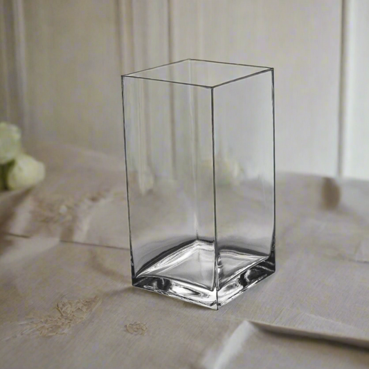 Clear glass cube on a textured surface with a blurred background