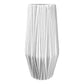 A ceramic round vase with a gloss finish, white body, with embossed black edges and a tapered bottom base.