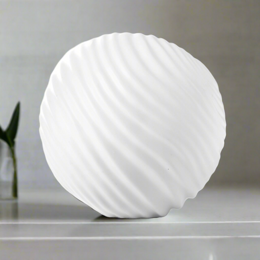 White spherical lamp on a gray surface with a blurred background