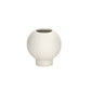 A matte white ceramic round vase with an embossed column and stripe design on the base.