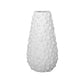 A white ceramic round bellied vase with a textured surface and a pattern of sphere studs.