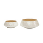 Two shallow round bowls with a textured off-white exterior and a light natural wood interior, shown on a plain white background.