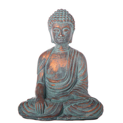 Two cement meditating Buddha figurines with a washed concrete finish, one in blue and one in gray, displayed against a brick backdrop with greenery.