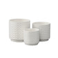 Three white ceramic planters with a geometric pattern on a white background