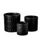 A set of three black ceramic round pots with a matte finish and embossed layered banded spike pattern