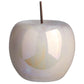 A polished pearlescent finish ceramic apple figurine with a stem.