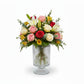 Bouquet of flowers in a clear glass vase on a white background